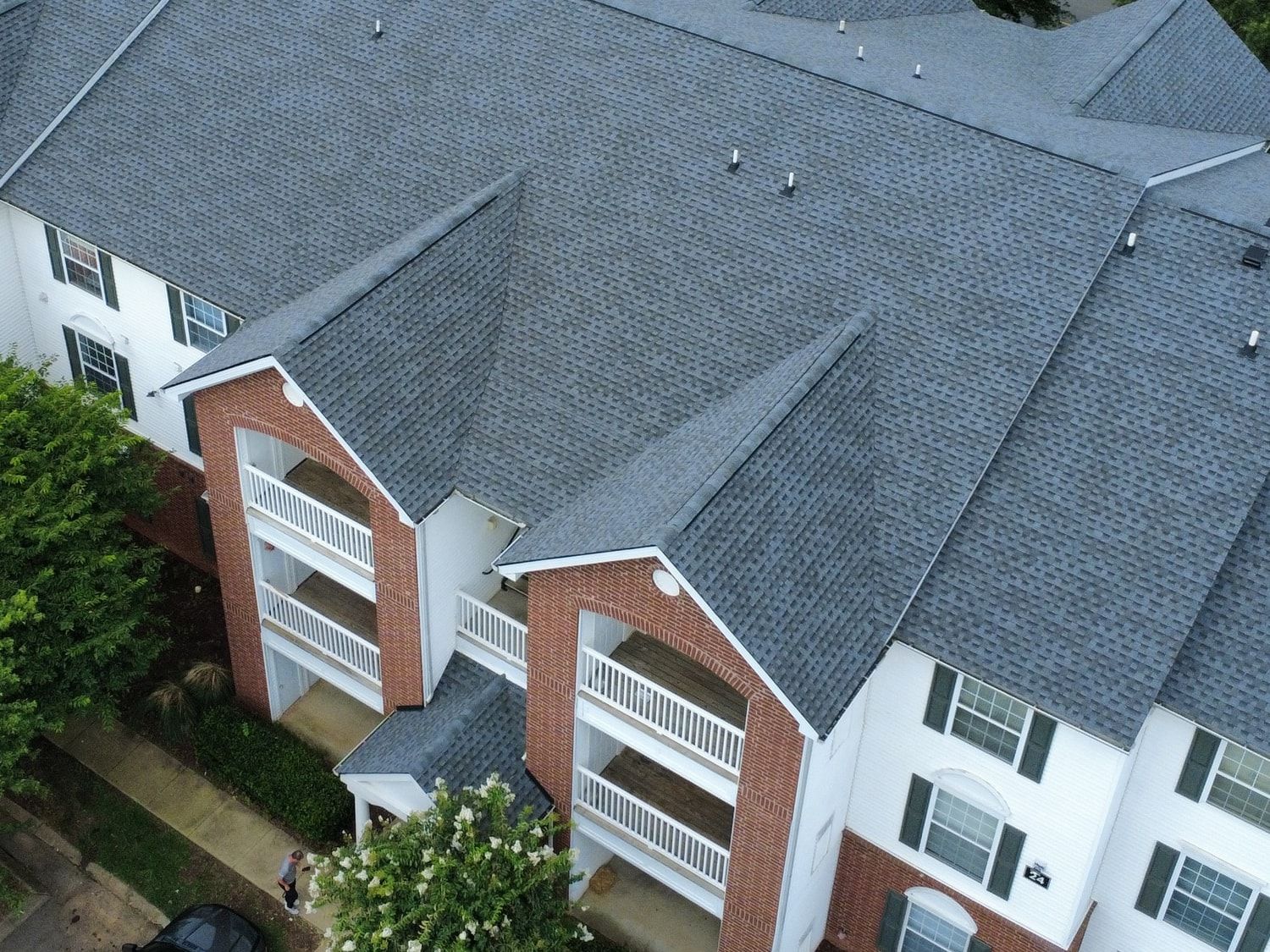 Close view of architectural shingles, dormers, valleys, and pipe flashing on a residential roof